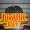 2 personnes tirant le dinosaure d'Arcade Machines Jurassic Game Console pour l'adulte d'intérieur